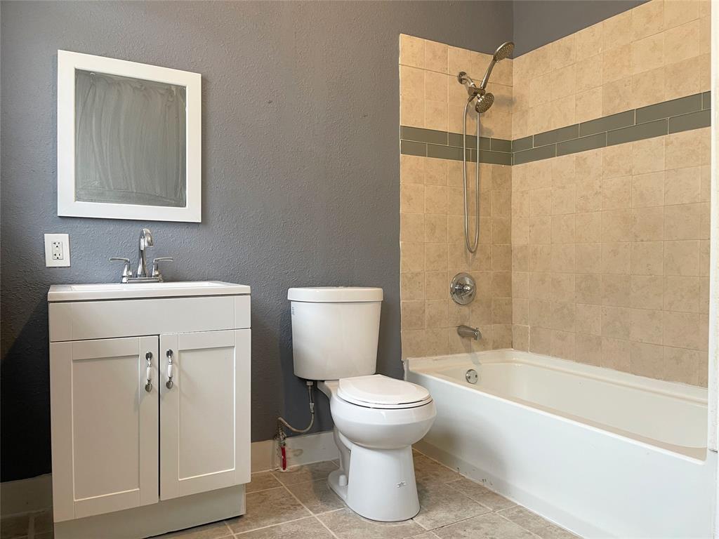 613 Northwest 5th Street Mineral Wells, TX 76067 - Photo 19 of 34 a bathroom with a sink toilet and shower