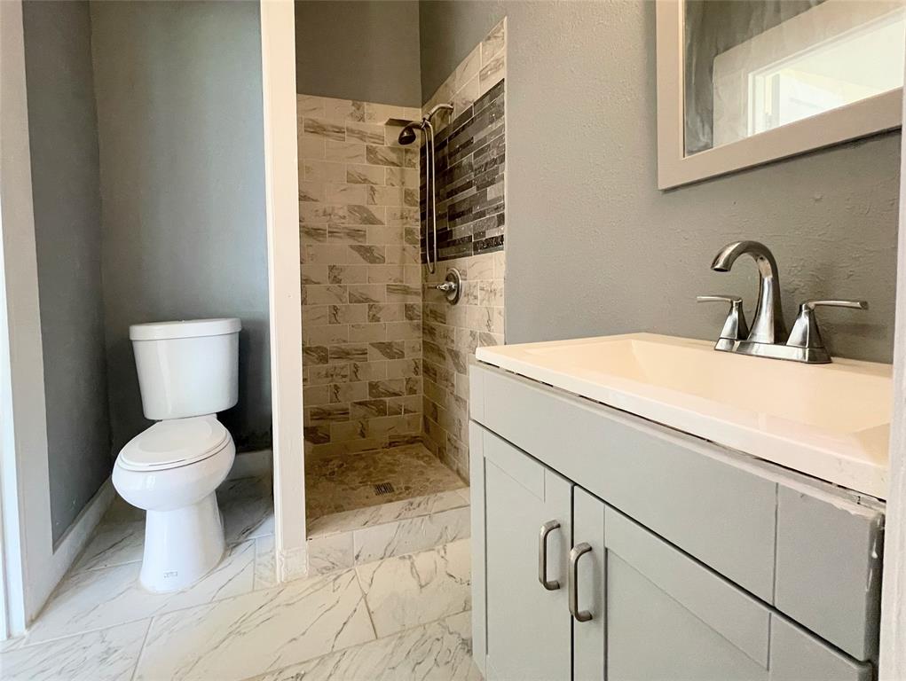 613 Northwest 5th Street Mineral Wells, TX 76067 - Photo 26 of 34 a bathroom with a sink toilet and shower