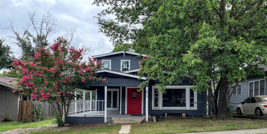 613 Northwest 5th Street Mineral Wells, TX 76067 - Photo 31 of 34 a front view of a house with a garden and tree