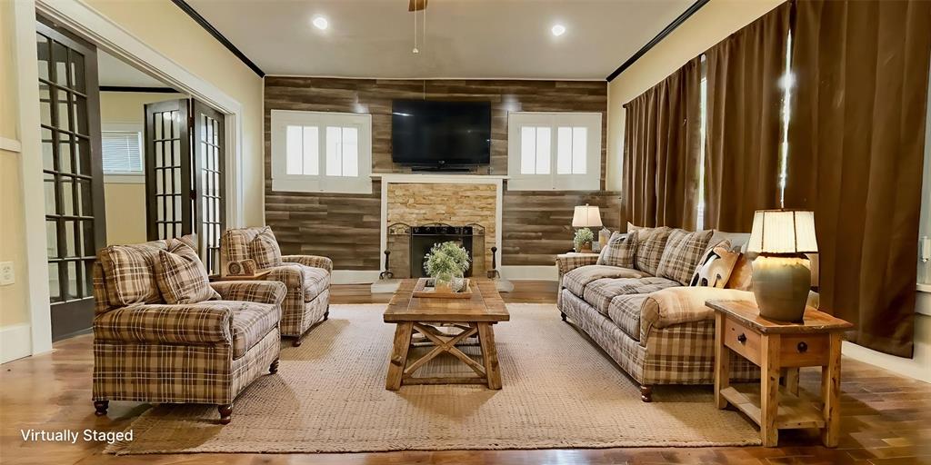 613 Northwest 5th Street Mineral Wells, TX 76067 - Photo 5 of 34 a living room with fireplace furniture and a flat screen tv