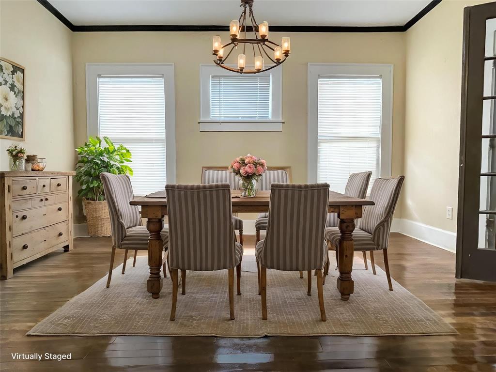 613 Northwest 5th Street Mineral Wells, TX 76067 - Photo 8 of 34 a dining room with furniture potted plants and wooden floor