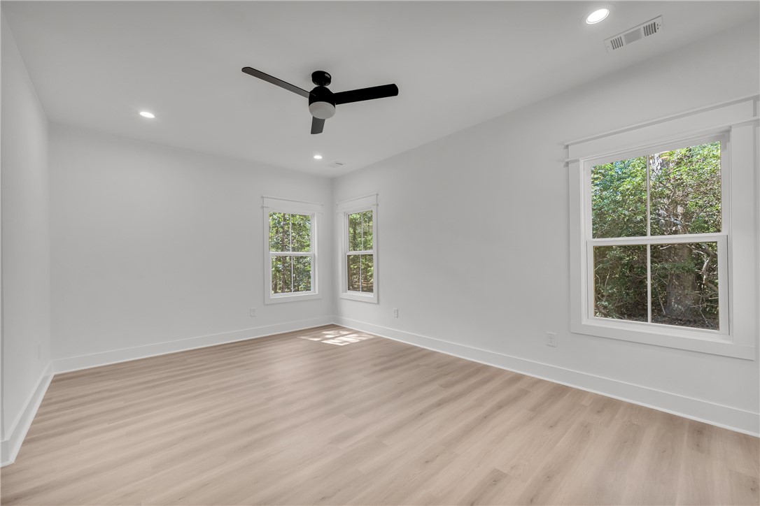659 White Oak Farms Road Tamassee, SC 29686 - Photo 42 of 50 Smooth wood floors and tall windows define this versatile secondary bedroom space.