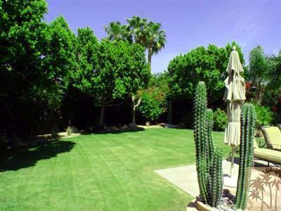 12 Silver Circle Rancho Mirage, CA 92270 - Photo 21 of 24 a backyard of a house with lots of green space and garden