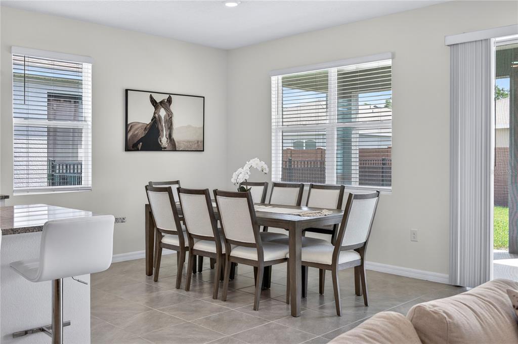 4975 Northwest 39th Loop Ocala, FL 34482 - Photo 12 of 76 a view of a dining room with furniture and windows