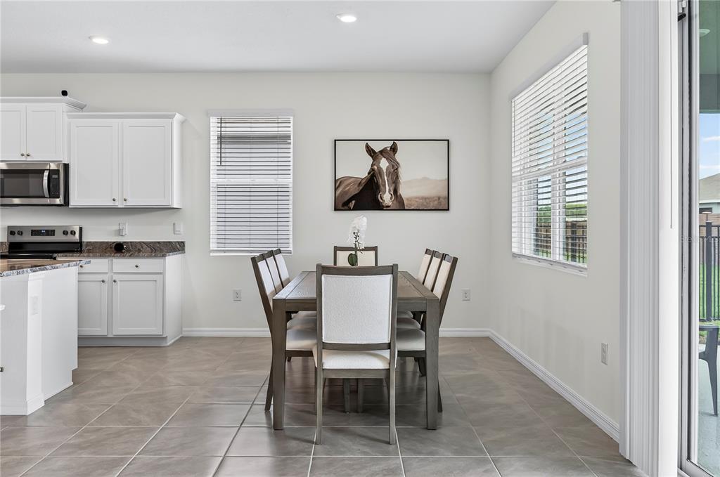 4975 Northwest 39th Loop Ocala, FL 34482 - Photo 13 of 76 a view of kitchen with cabinets stainless steel appliances dining table and chairs