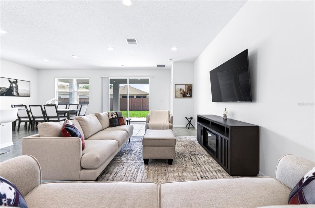 4975 Northwest 39th Loop Ocala, FL 34482 - Photo 15 of 76 a living room with furniture and a flat screen tv