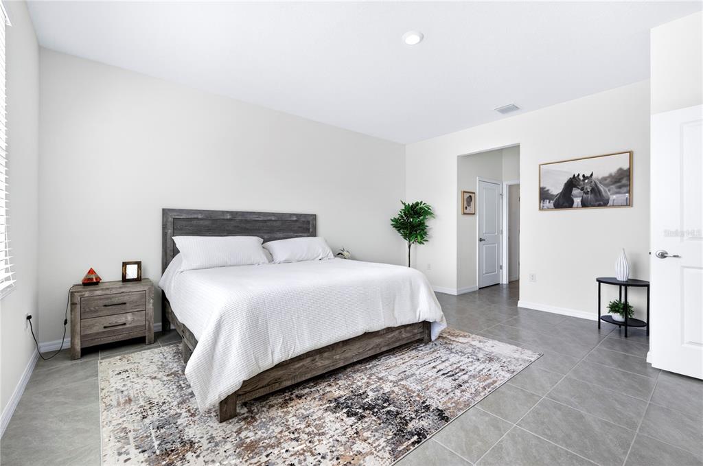 4975 Northwest 39th Loop Ocala, FL 34482 - Photo 22 of 76 a bedroom with a bed and a couch