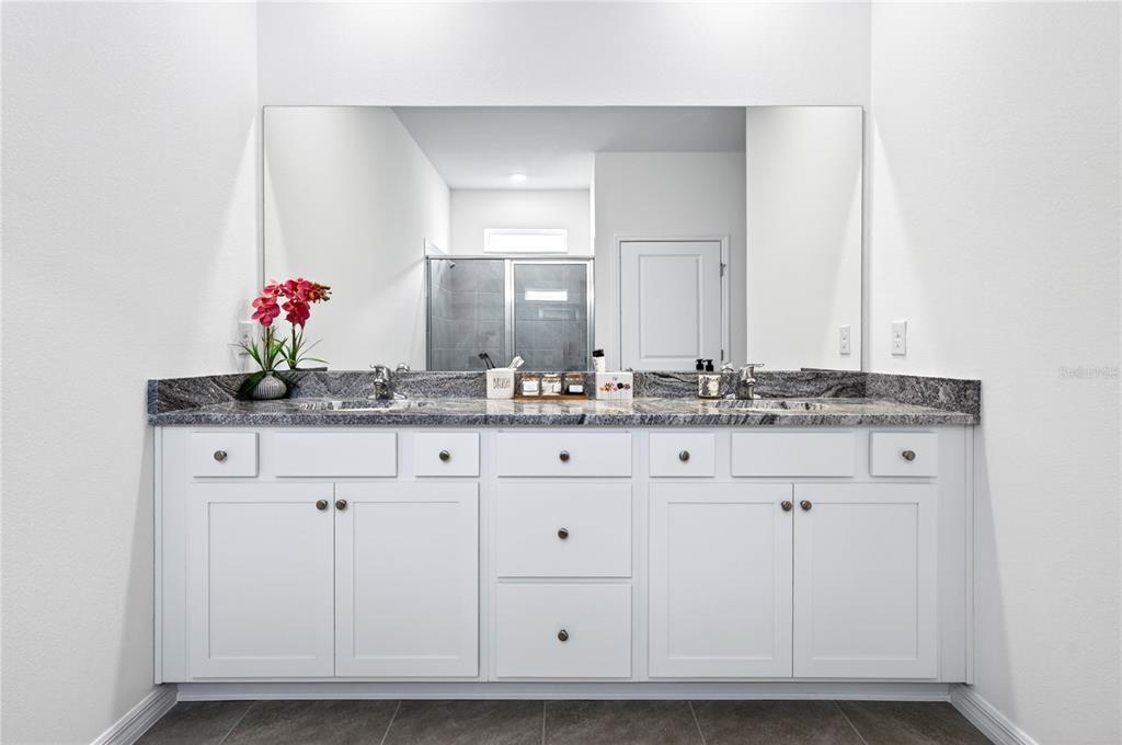 4975 Northwest 39th Loop Ocala, FL 34482 - Photo 26 of 76 a bathroom with a sink vanity and mirror