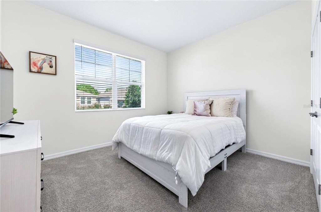4975 Northwest 39th Loop Ocala, FL 34482 - Photo 29 of 76 a bed sitting in a bedroom next to a window