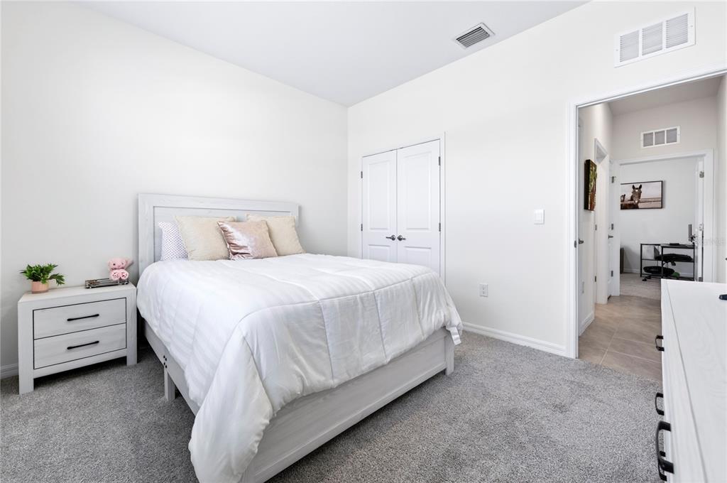 4975 Northwest 39th Loop Ocala, FL 34482 - Photo 30 of 76 a bed room with a bed and a chair