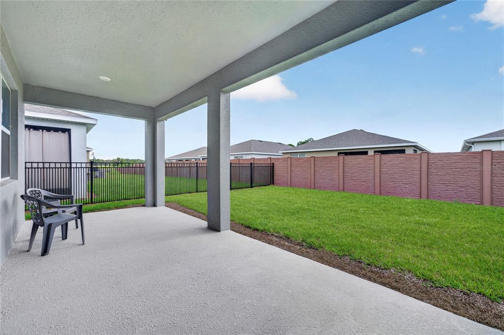 4975 Northwest 39th Loop Ocala, FL 34482 - Photo 3 of 76 a view of a backyard with couches plants and wooden fence
