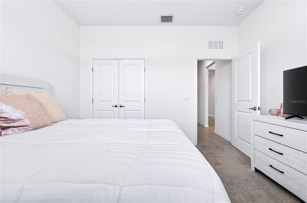 4975 Northwest 39th Loop Ocala, FL 34482 - Photo 31 of 76 a bedroom with a bed and a flat screen tv