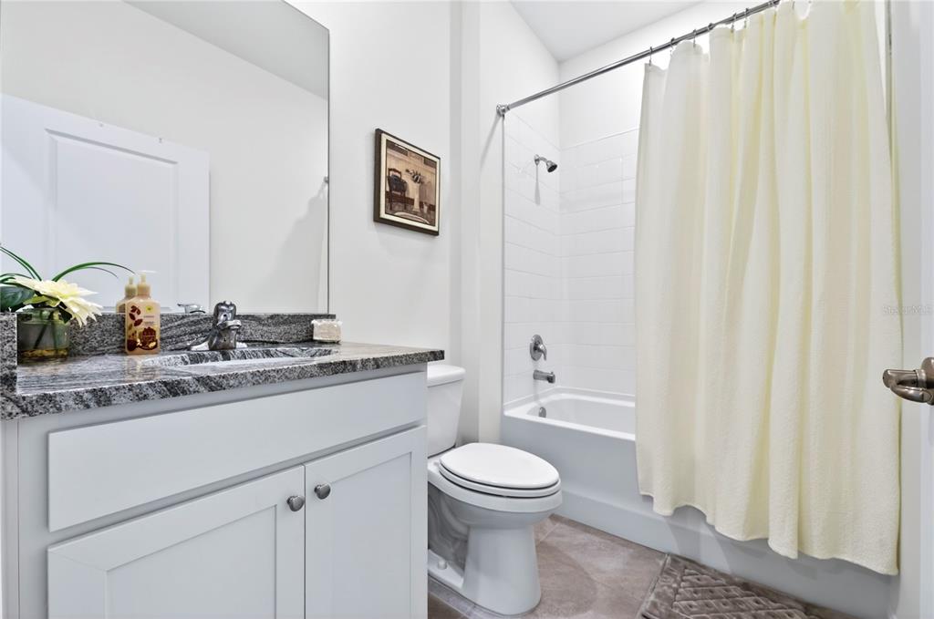 4975 Northwest 39th Loop Ocala, FL 34482 - Photo 32 of 76 a bathroom with a granite countertop sink toilet and shower