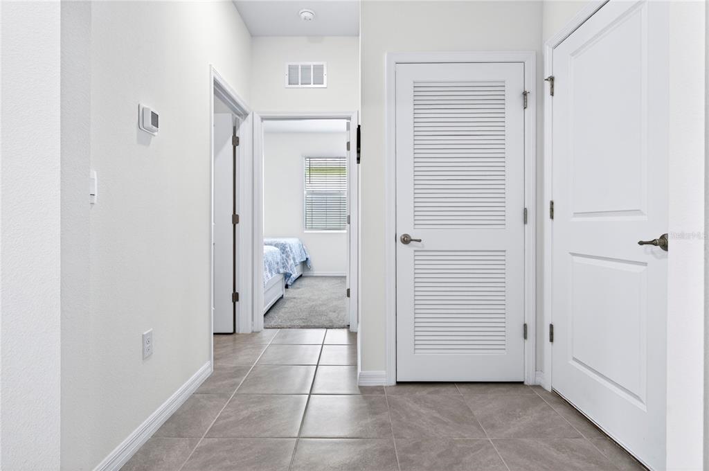 4975 Northwest 39th Loop Ocala, FL 34482 - Photo 36 of 76 a view of a bathroom with a glass door and a hallway