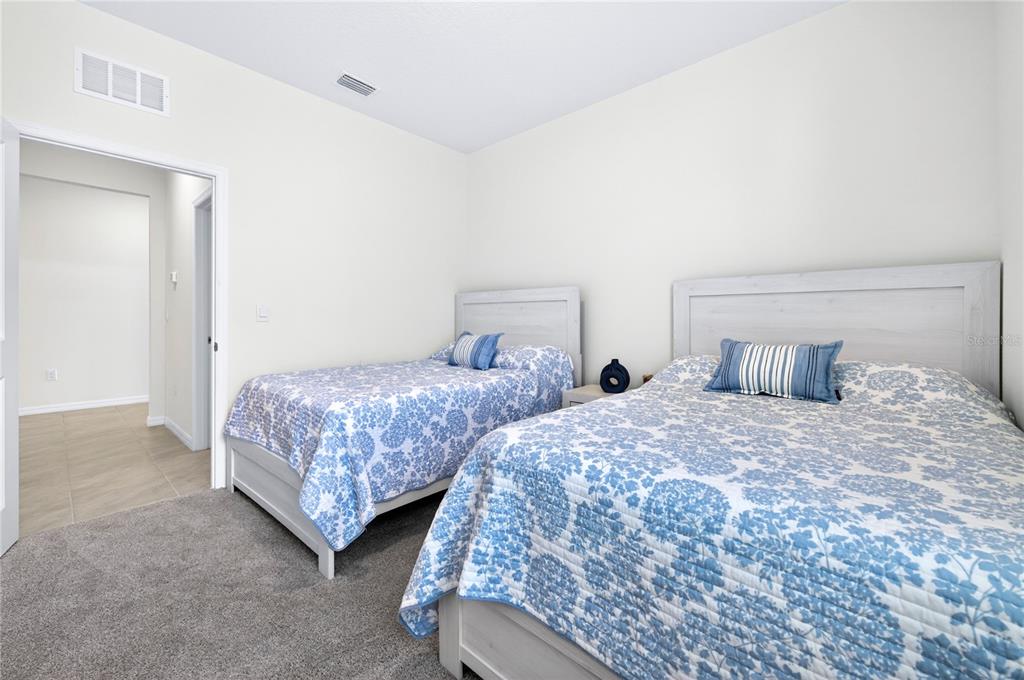 4975 Northwest 39th Loop Ocala, FL 34482 - Photo 38 of 76 a bedroom with two beds and painting on the wall