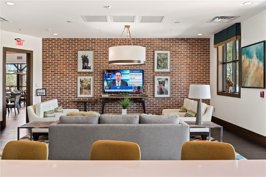 4975 Northwest 39th Loop Ocala, FL 34482 - Photo 67 of 76 a living room with furniture a flat screen tv and a fireplace