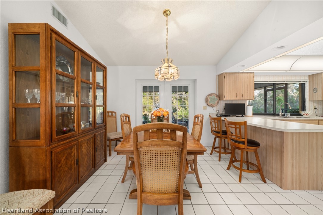 5802 Golden Road Sebring, FL 33875 - Photo 10 of 37 a dining room with furniture a chandelier and window