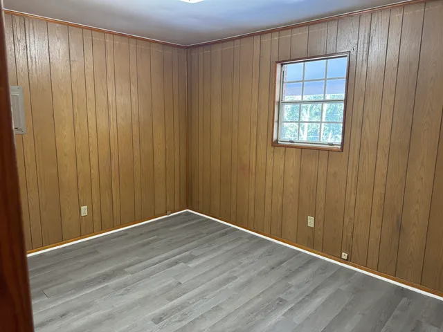 an empty room with wooden floor