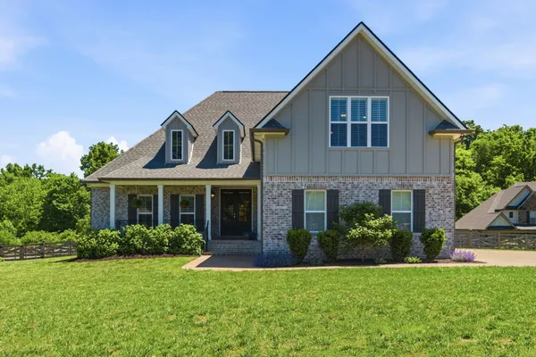 a front view of a house with a yard and garage