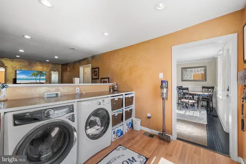 a view of washer and dryer with kitchen in the background