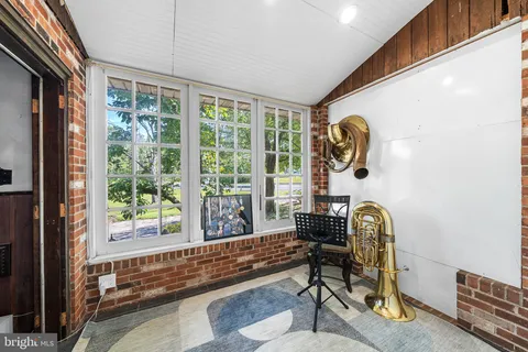 a living room filled with furniture and a window
