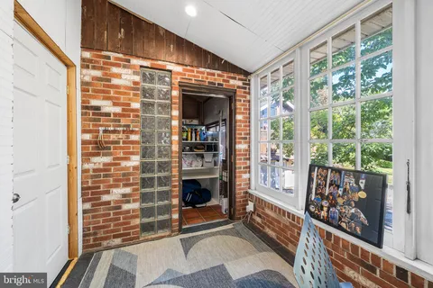 a view of an entryway with wooden floor and garden