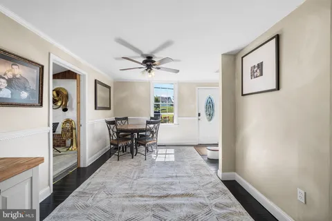 a view of a hallway with workspace and a window