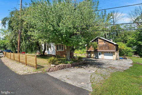a view of a house with a tree and yard