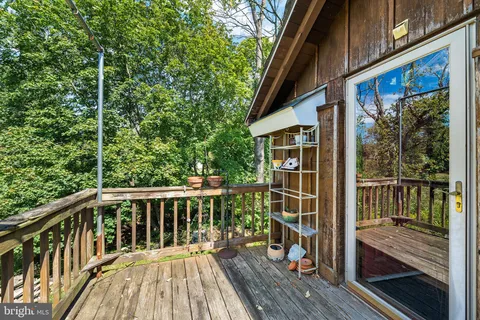 a view of balcony with wooden floor and fence