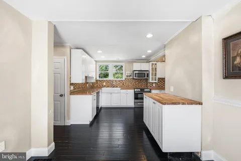 a kitchen with white cabinets and white appliances
