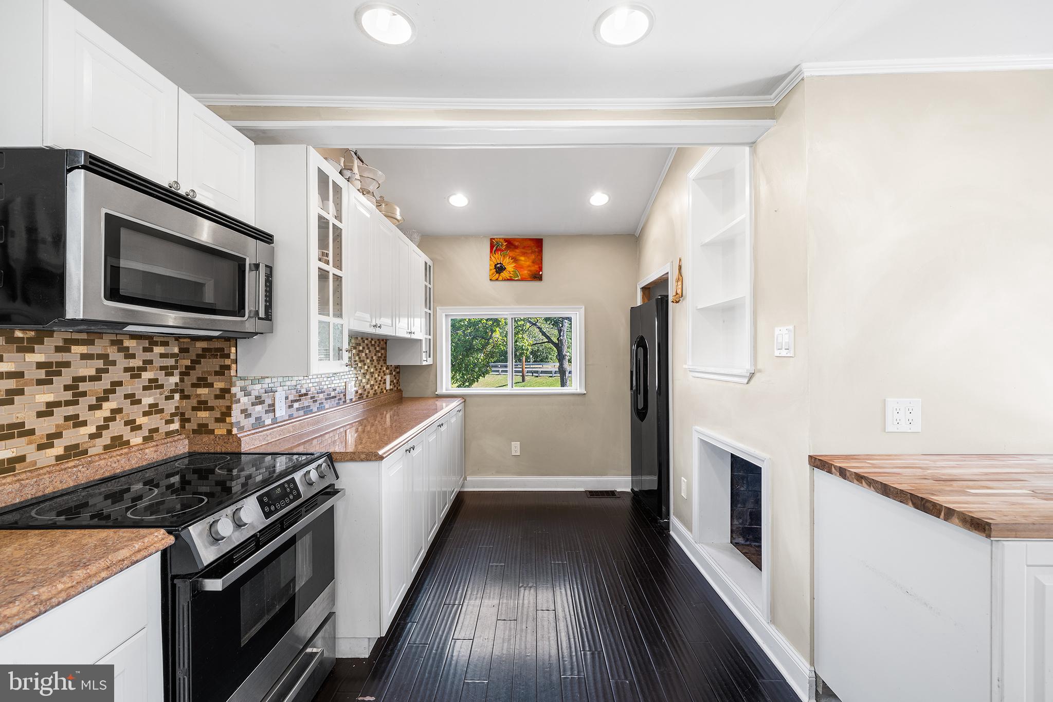 787 North Lewis Road Royersford, PA 19468 - Photo 7 of 53 a kitchen with granite countertop stainless steel appliances a sink stove top oven and microwave