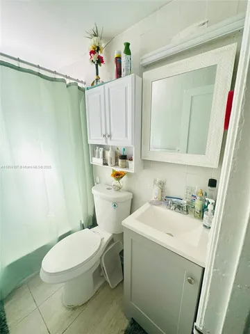 a white toilet sitting next to a bathroom sink