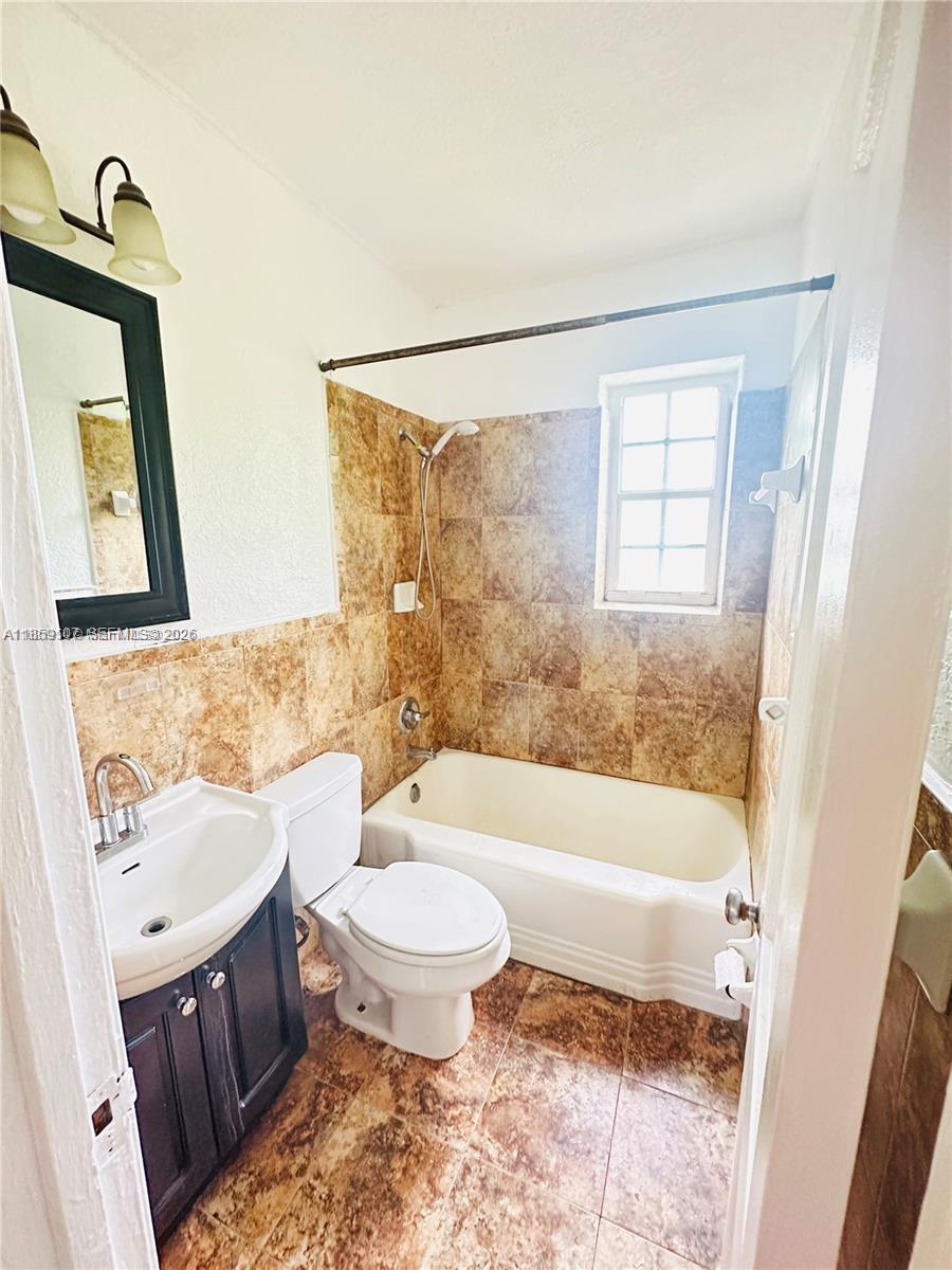 2371 Southwest 27th Street Miami, FL 33133 - Photo 7 of 12 a bathroom with a sink toilet and shower