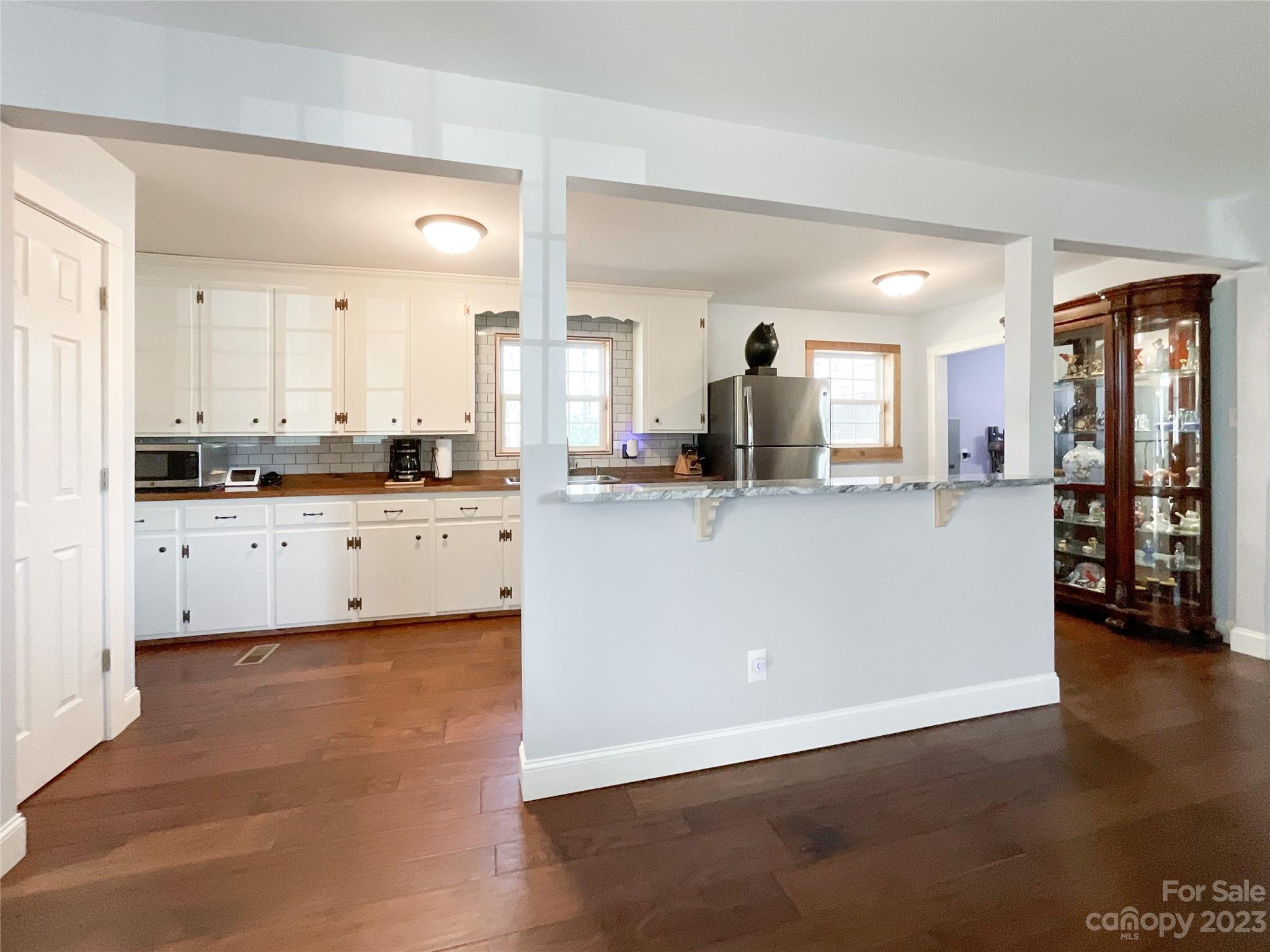4423 Austin Road Monroe, NC 28112 - Photo 11 of 31 a kitchen with granite countertop a sink cabinets and wooden floor