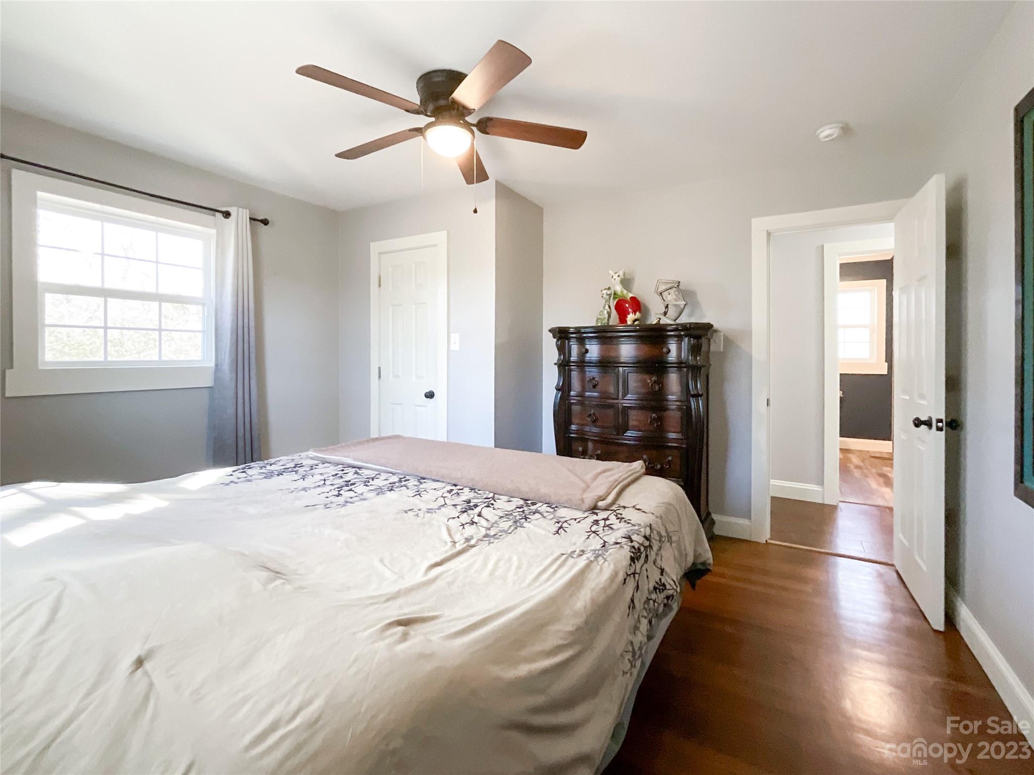 4423 Austin Road Monroe, NC 28112 - Photo 17 of 31 a bed room with a bed and a chandelier