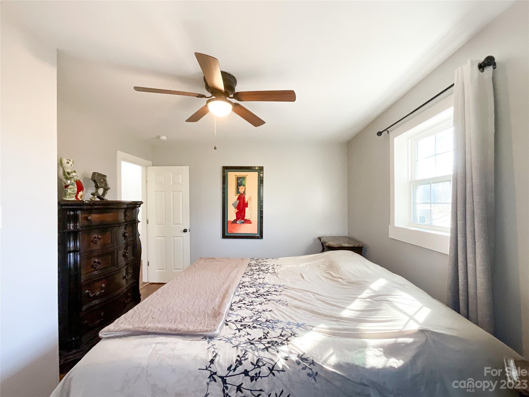 4423 Austin Road Monroe, NC 28112 - Photo 18 of 31 a bedroom with a bed and a chandelier