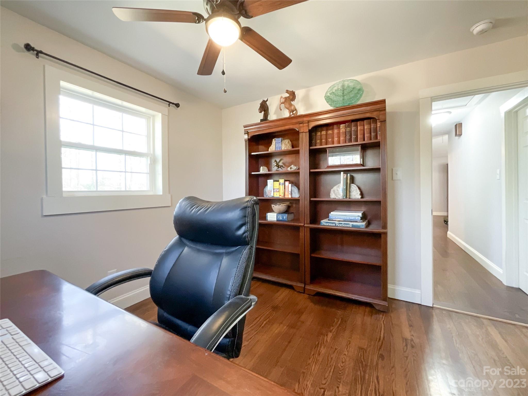 4423 Austin Road Monroe, NC 28112 - Photo 21 of 31 a room with workspace and wooden floor