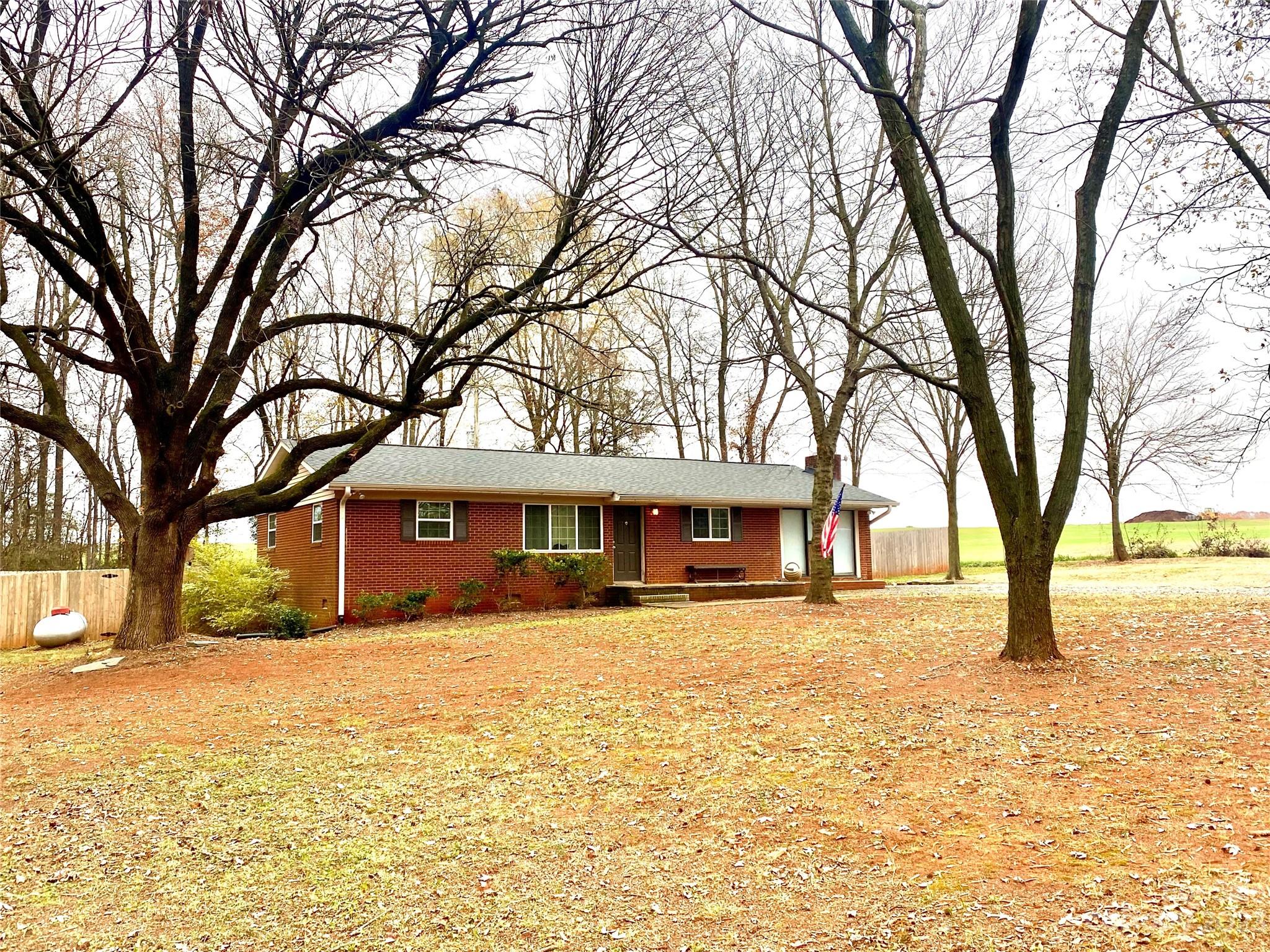 4423 Austin Road Monroe, NC 28112 - Photo 4 of 31 a house with trees in front of it