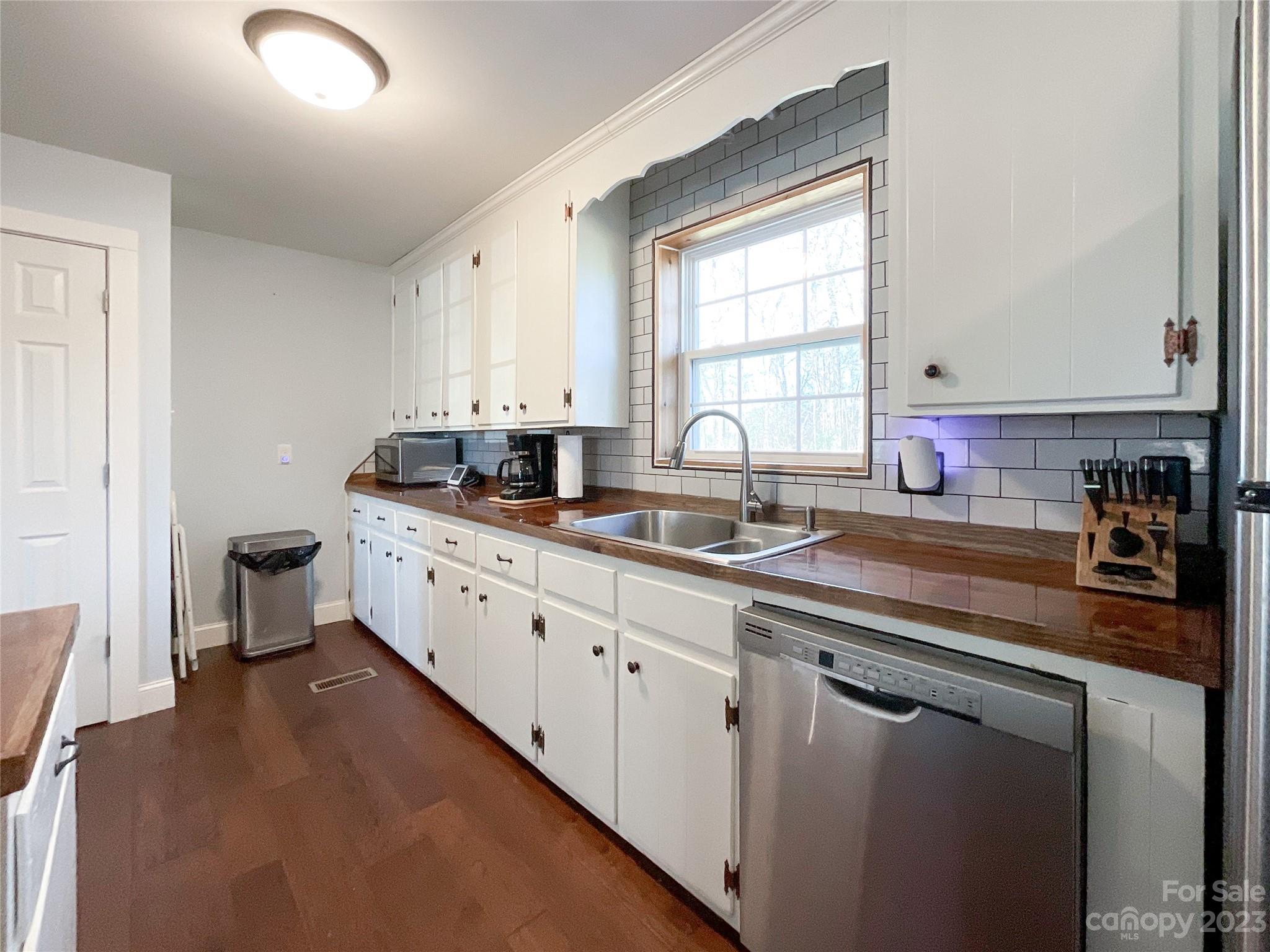 4423 Austin Road Monroe, NC 28112 - Photo 5 of 31 a kitchen with stainless steel appliances a sink stove and cabinets