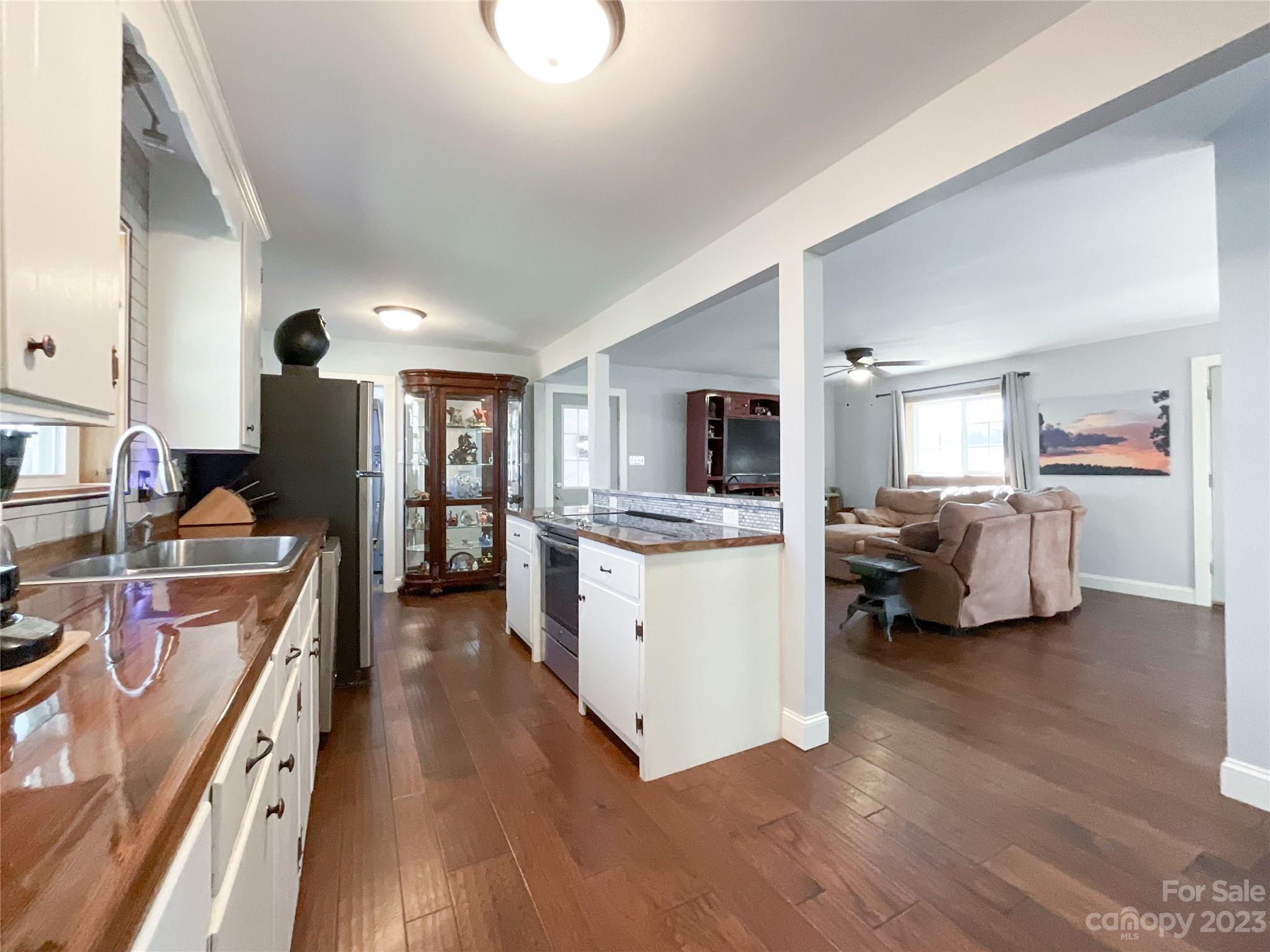 4423 Austin Road Monroe, NC 28112 - Photo 8 of 31 a open kitchen with stainless steel appliances kitchen island a stove and a refrigerator