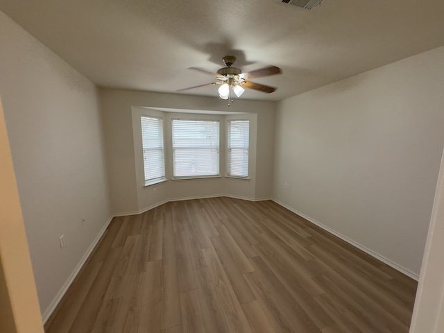 109 Plover Pass Georgetown, TX 78633 - Photo 15 of 25 Spare room with wood finished floors and a ceiling fan
