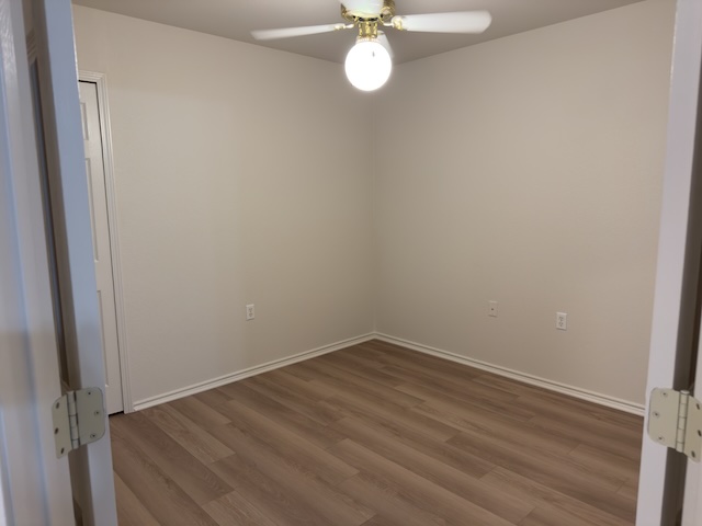109 Plover Pass Georgetown, TX 78633 - Photo 17 of 25 Unfurnished bedroom with ceiling fan and dark wood-style flooring