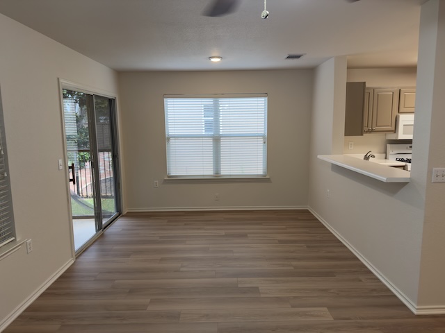 109 Plover Pass Georgetown, TX 78633 - Photo 19 of 25 Unfurnished dining area featuring dark wood finished floors and ceiling fan
