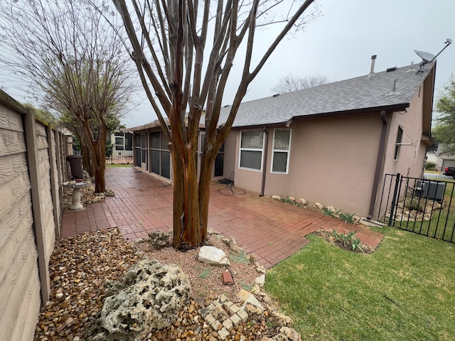109 Plover Pass Georgetown, TX 78633 - Photo 2 of 25 Rear view of property featuring a fenced backyard, a patio, stucco siding, and a shingled roof