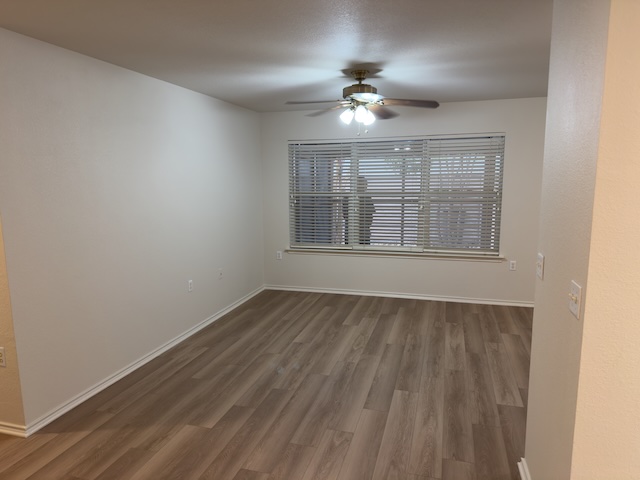 109 Plover Pass Georgetown, TX 78633 - Photo 21 of 25 Empty room with dark wood-style floors and ceiling fan