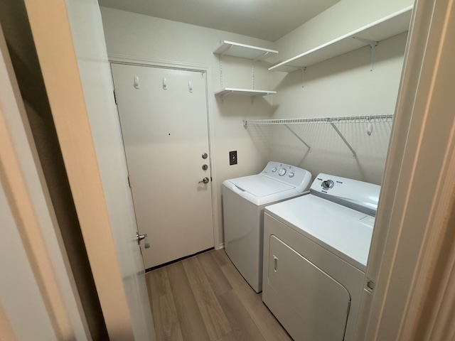 109 Plover Pass Georgetown, TX 78633 - Photo 8 of 25 Laundry room featuring light wood-type flooring and washing machine and dryer