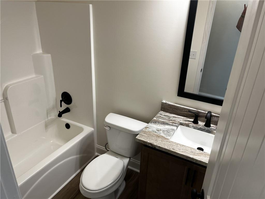 1932 Cochran Ridge Road Hiram, GA 30141 - Photo 16 of 30 a bathroom with a sink a toilet and a mirror