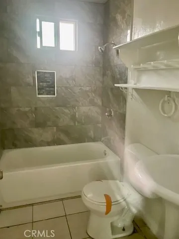 a bathroom with a toilet and a bathtub