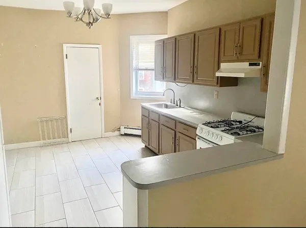 a kitchen with stainless steel appliances granite countertop a sink a stove and a refrigerator
