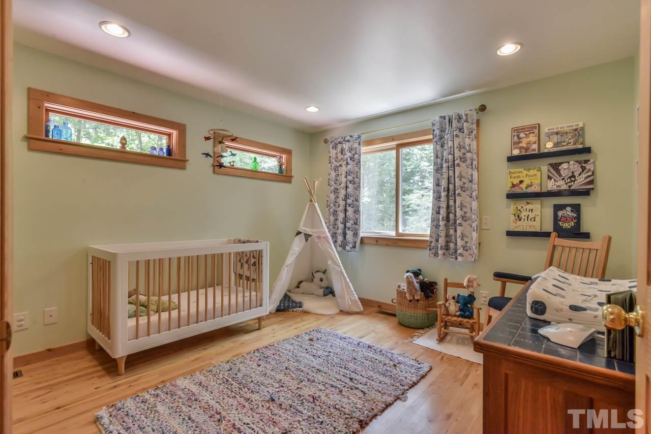 8710 Morrow Mill Road Mebane, NC 27302 - Photo 13 of 24 This second floor bedroom has a large walk-in closet, hardwood floors, great natural light and a treetop view. Previous owners used this as the master bedroom and main level bedroom as guest space.